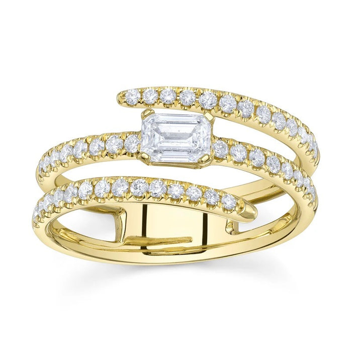 Gold ring with emerald-cut center stone and diamond accents on a white background