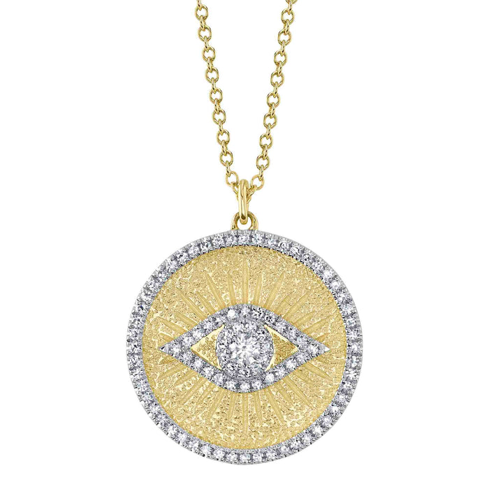 A gold necklace with a circular medallion featuring an evil eye design surrounded by diamonds